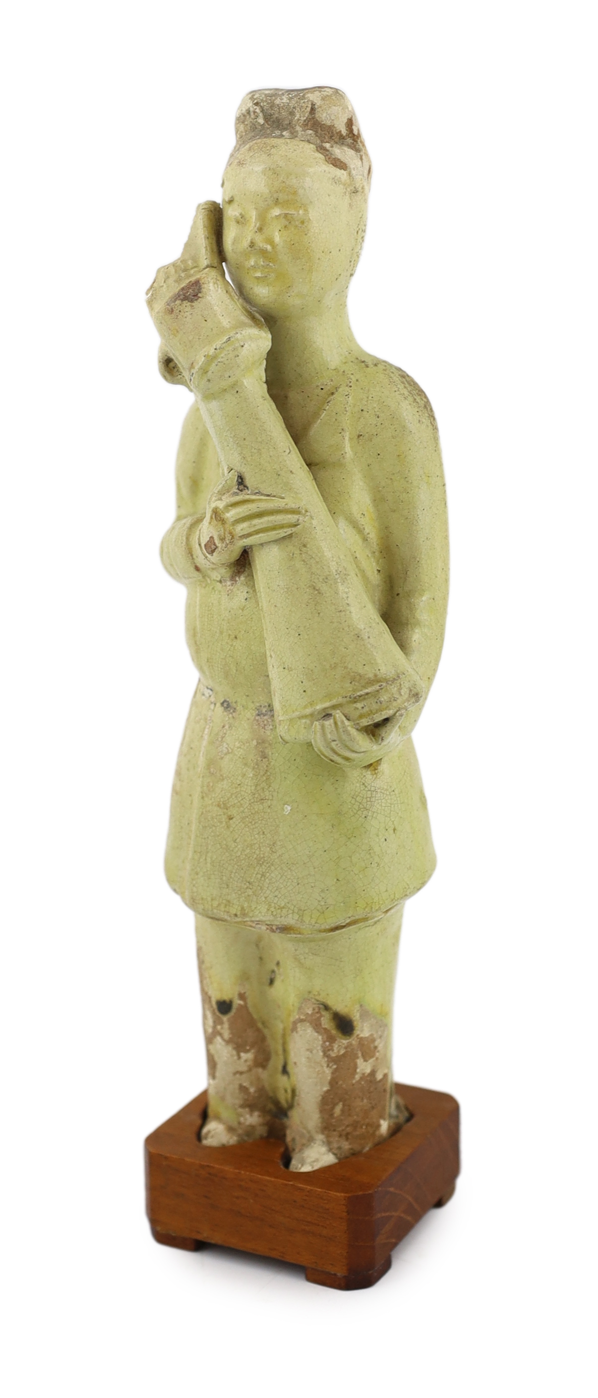 A Chinese pale green glazed pottery figure of an attendant, Tang dynasty (618-906 AD)